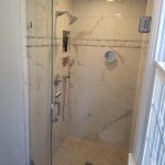 Bathroom renovations with tan shower stall