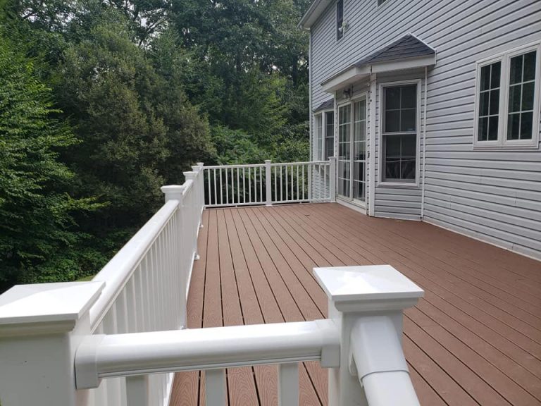 Deck with white rails on gray house