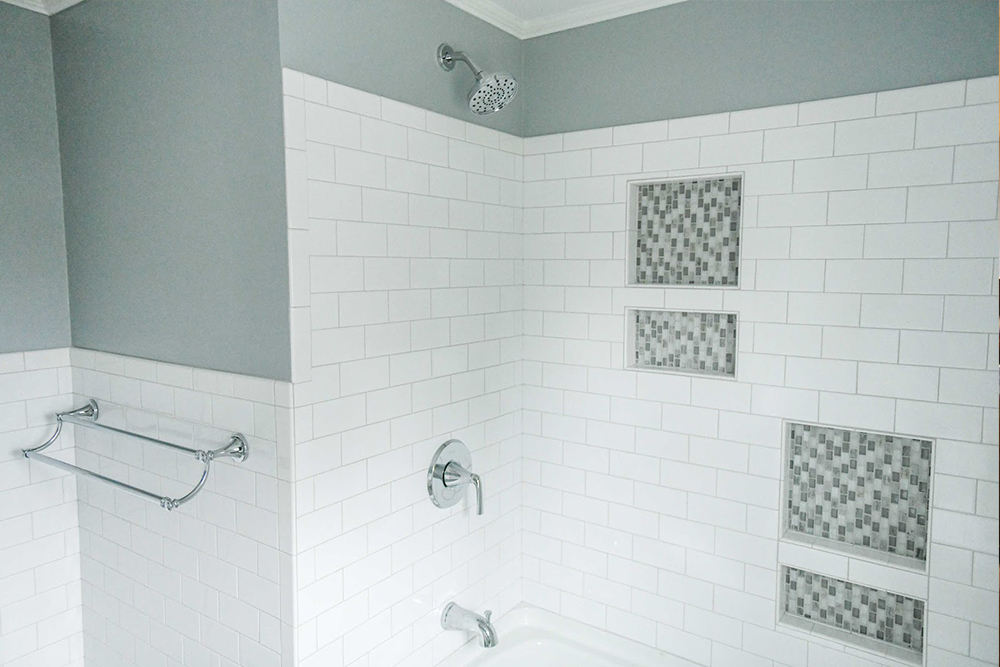 Finished shower renovation with new tile and fixtures