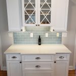 Kitchen addition showing bar with drawers and glass front cabinets in Avon, CT