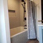 Bathroom renovation included new tub and shower with tile surround