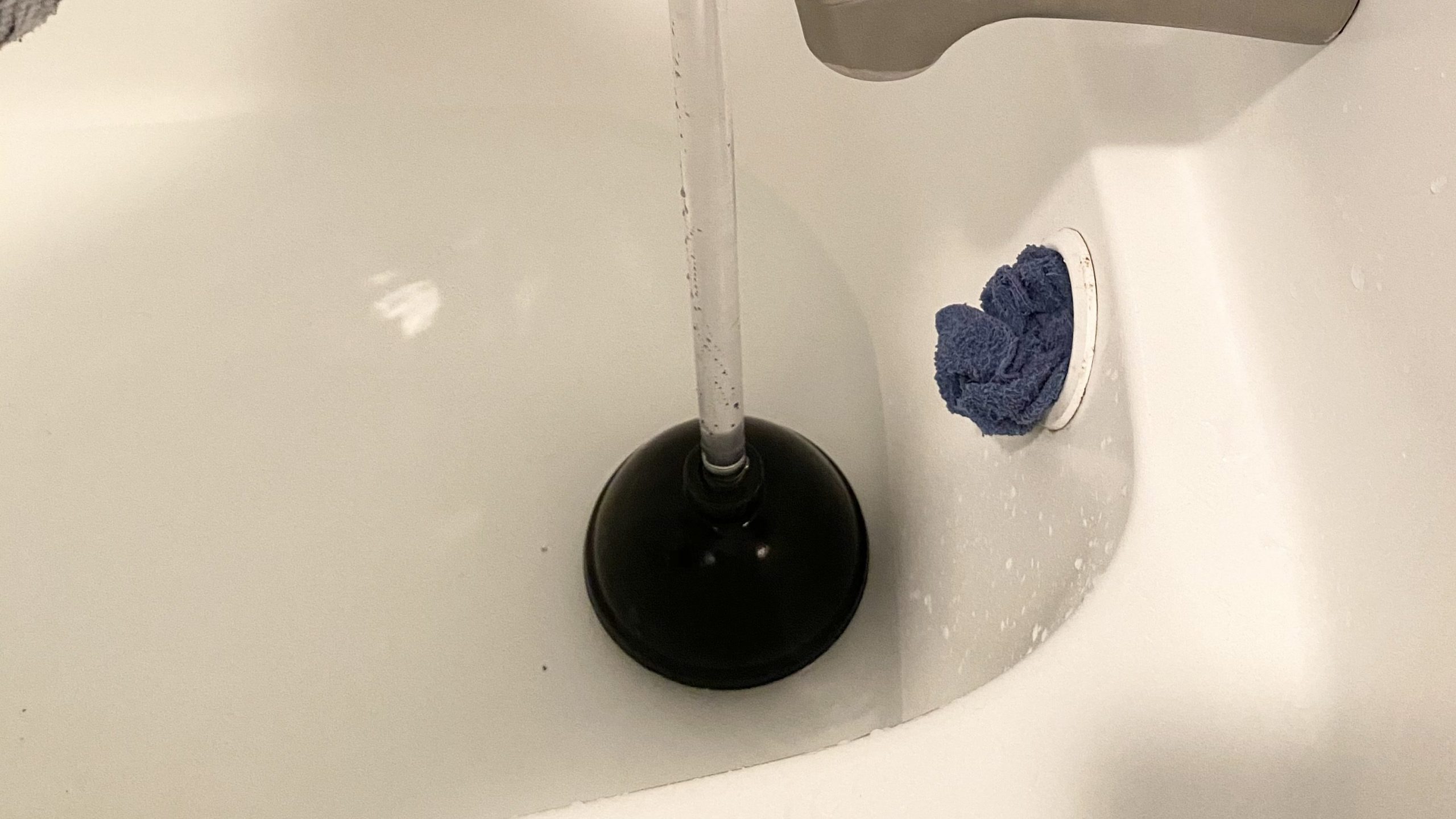 unclogging your tub with a plunger