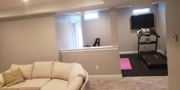 Basement renovation with tv room and fitness area
